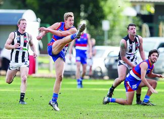 Consistency works for Bulldogs Castlemaine's Kal Huntly shrugs off a tackle from Gisborne's Thomas Wood. Photo: Peter Banko