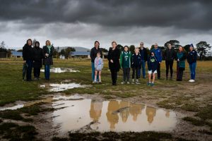 Greens candidate for Northern Victoria Nicole Rowan (centre) on site at the proposed sports precinct location with members of the Macedon Ranges volleyball, netball, basketball and futsal community. Photo: Julian Meehan