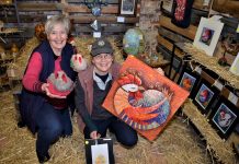Chicken art hatches enterprise Friends of Lolotoe secretary/treasurer Chris Sertori and The Drying Shed's Linda Newton with examples of the artworks in Manu Feto Chicken Art Show.