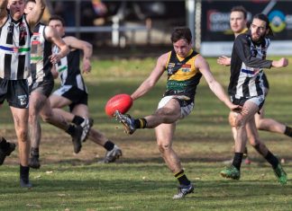 Strong second half downs Magpies Max O'Sullivan snap kicks towards goal. Photo: Peter Banko
