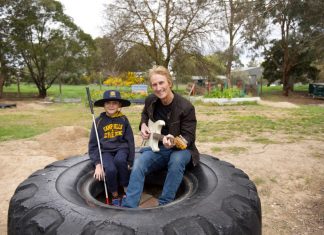 Concert for Jarrah Nine-year-old Jarrah Podesta with John Farnham Band guitarist Brett Garsed. Photo: Dean McLaren