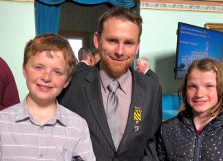 Devotion to duty Newstead publican Trevor Mitchell is pictured with his Conspicuous Service Cross and his children Tom and Claire at Government House on September 5.