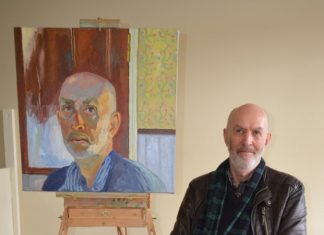 Local finalist Castlemaine artist Mark Dober is pictured with his self-portrait.