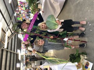 Fergus, Stacy and Poppy celebrate their triumph in the farm produce section, winning best exhibit with a giant cabbage. Photo: Raina Kilner
