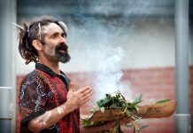 New beginning Proud Dja Dja Wurrung man Damien Saunders conducts a smoking ceremony at Trentham District Primary School last Friday morning to celebrate the installation of a new flag pole to fly the Aboriginal flag. "This ceremony today was the new beginning through the old for tomorrow's youth," he said. Photo: Sandy Scheltema