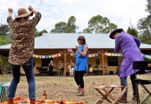 Women celebrate Cate Mercer of Castlemaine, Gen Ward of Castlemaine and Beverley Hope of Guildford couldn't resist the chance to get up and dance during Friday's International Women's Day celebration in the botanical gardens.