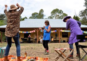 Cate Mercer of Castlemaine, Gen Ward of Castlemaine and Beverley Hope of Guildford couldn't resist the chance to get up and dance during Friday's International Women's Day celebration in the botanical gardens.